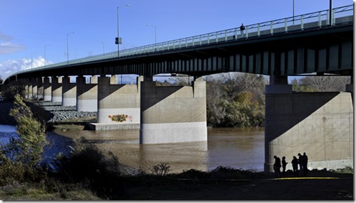 Chris Kaufman/Appeal-Democrat Yuba City Police officers and Sutter County Sheriff's deputies investigate the scene where a body was discovered Sunday, December 2, 2012 under the 10th Street Bridge in Yuba City.